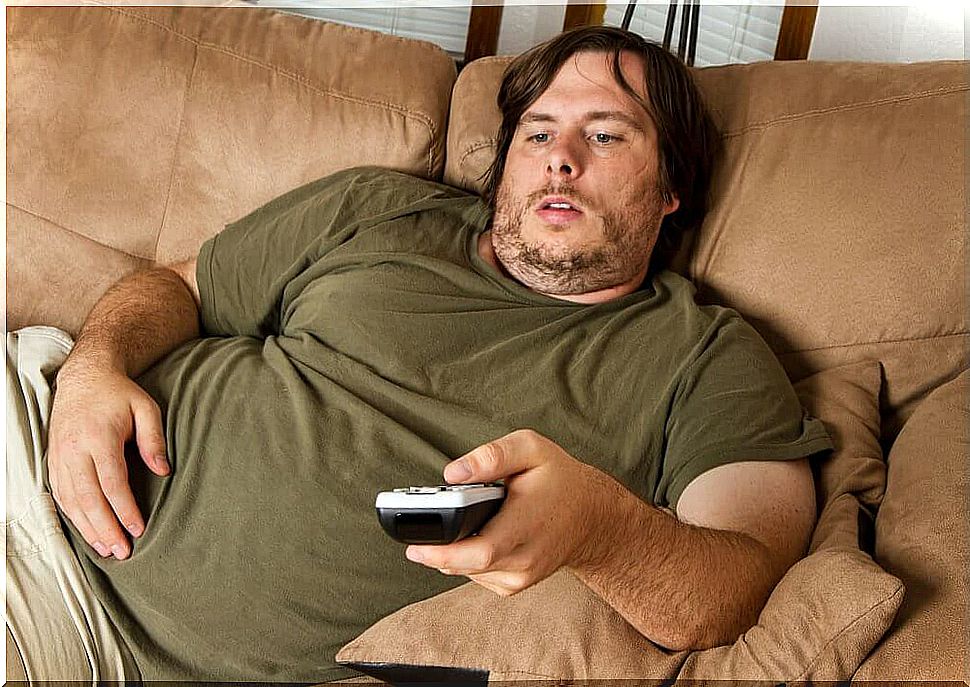 Overweight man with remote control
