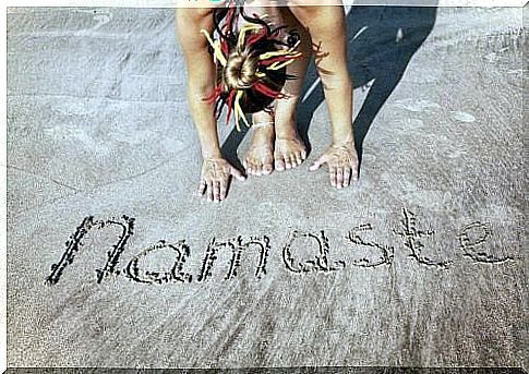 Namaste written in sand